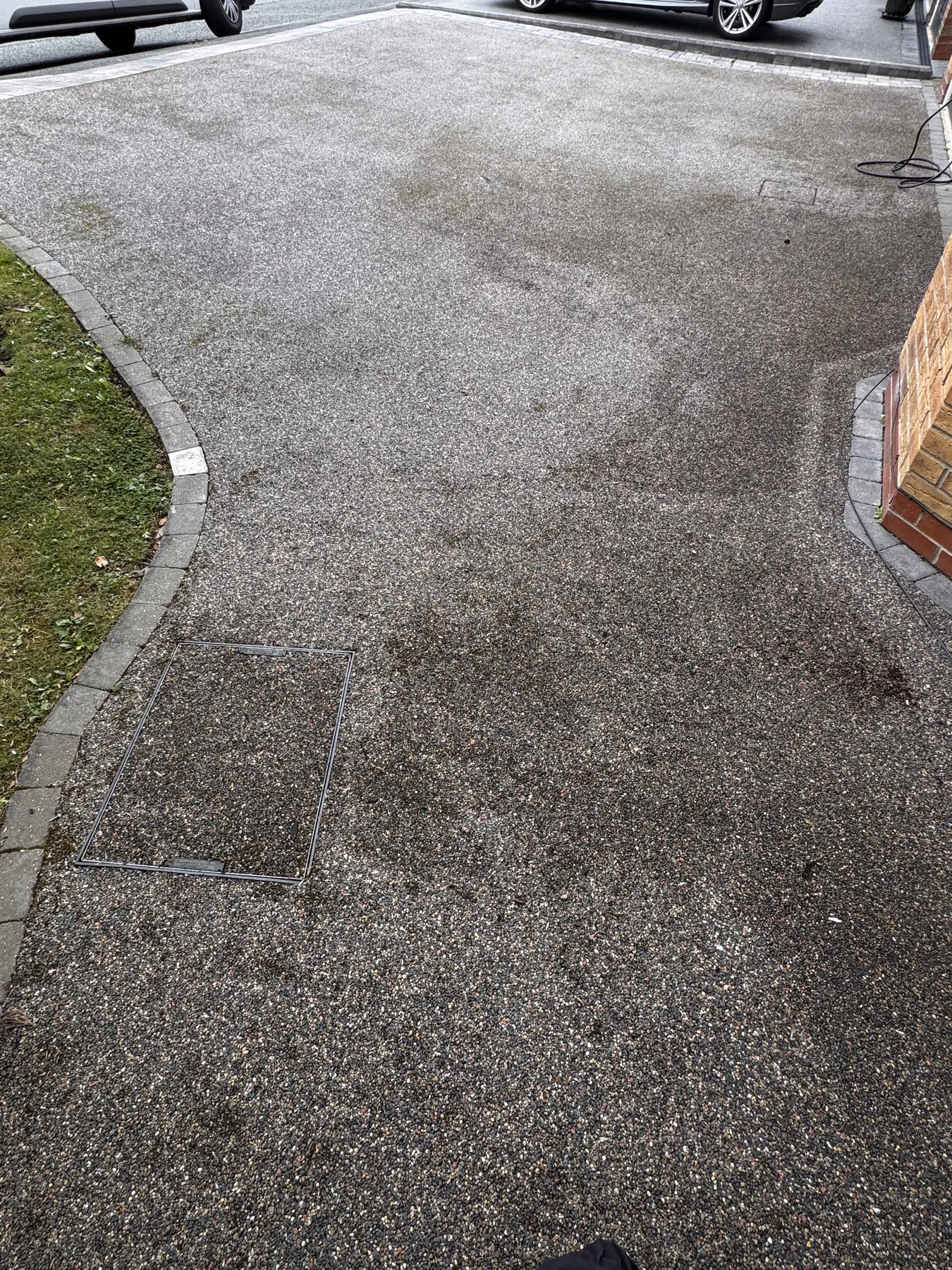Stained resin driveway before professional cleaning