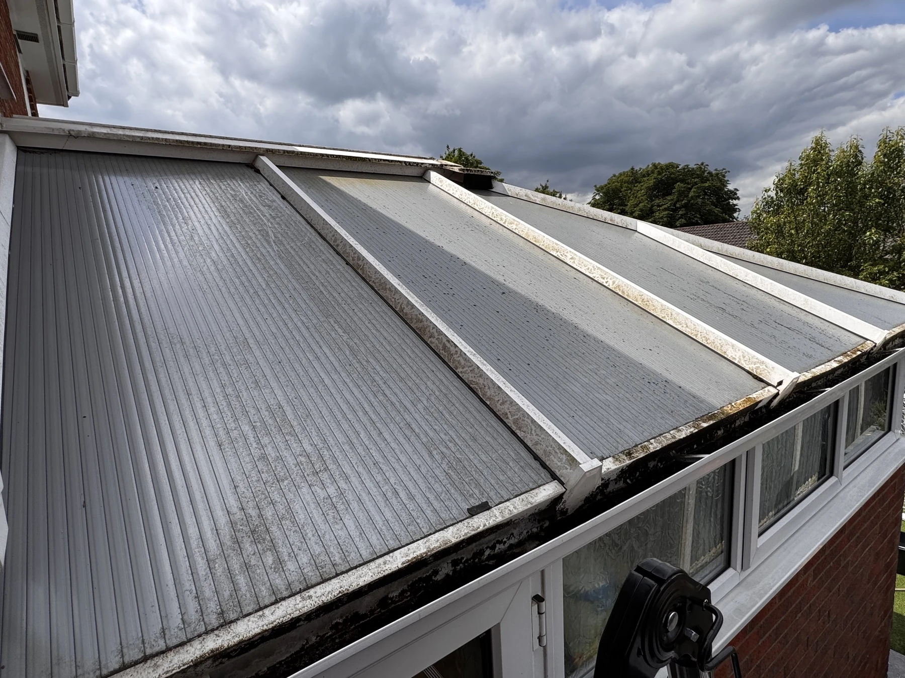 Stained conservatory roof before professional cleaning