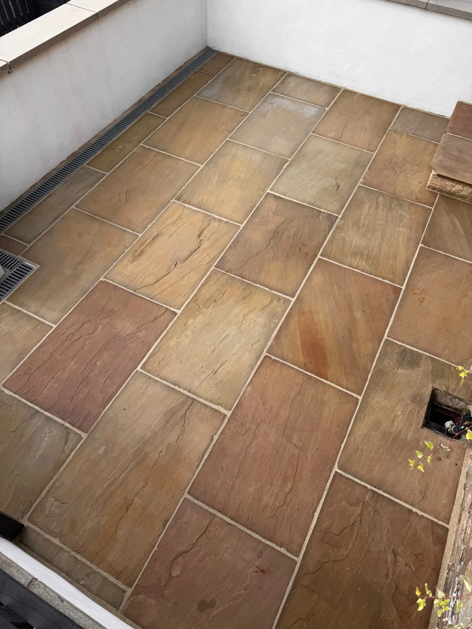 Cleaned stone courtyard patio after professional exterior cleaning