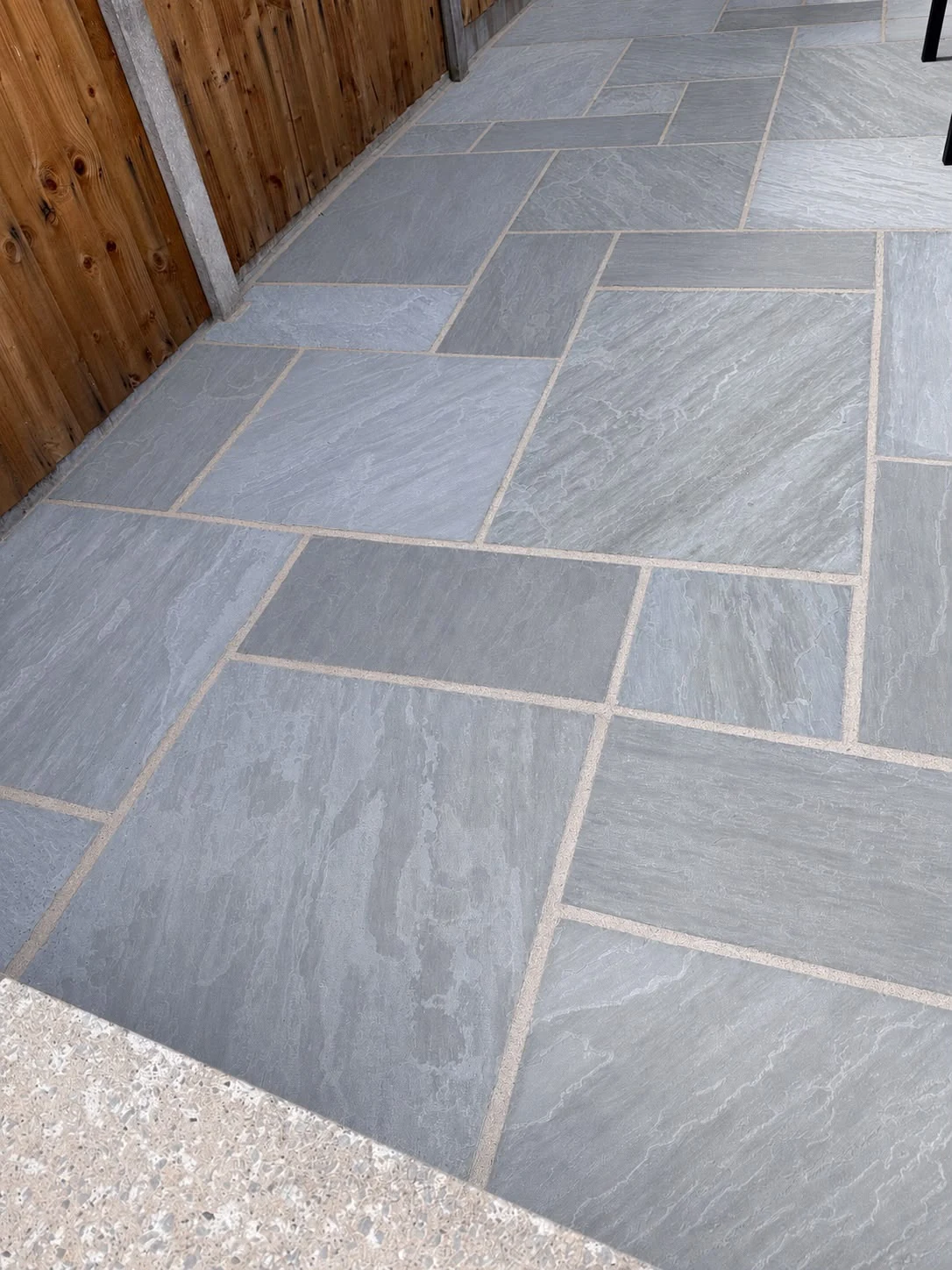 Grey stone patio before and after professional exterior cleaning after