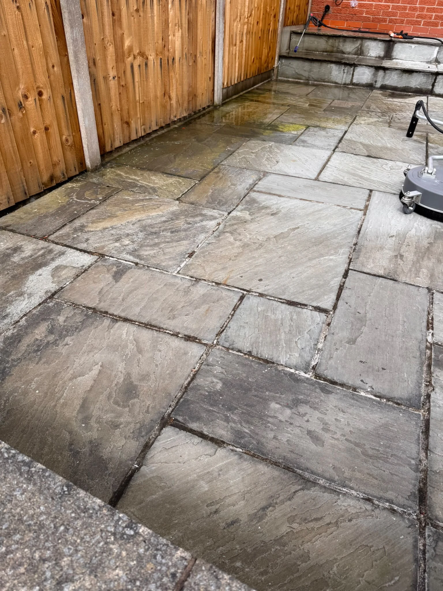 Grey stone patio before and after professional exterior cleaning before
