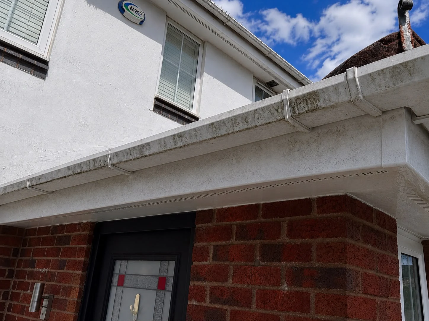 Clean white gutter, fascia and soffit after professional exterior cleaning