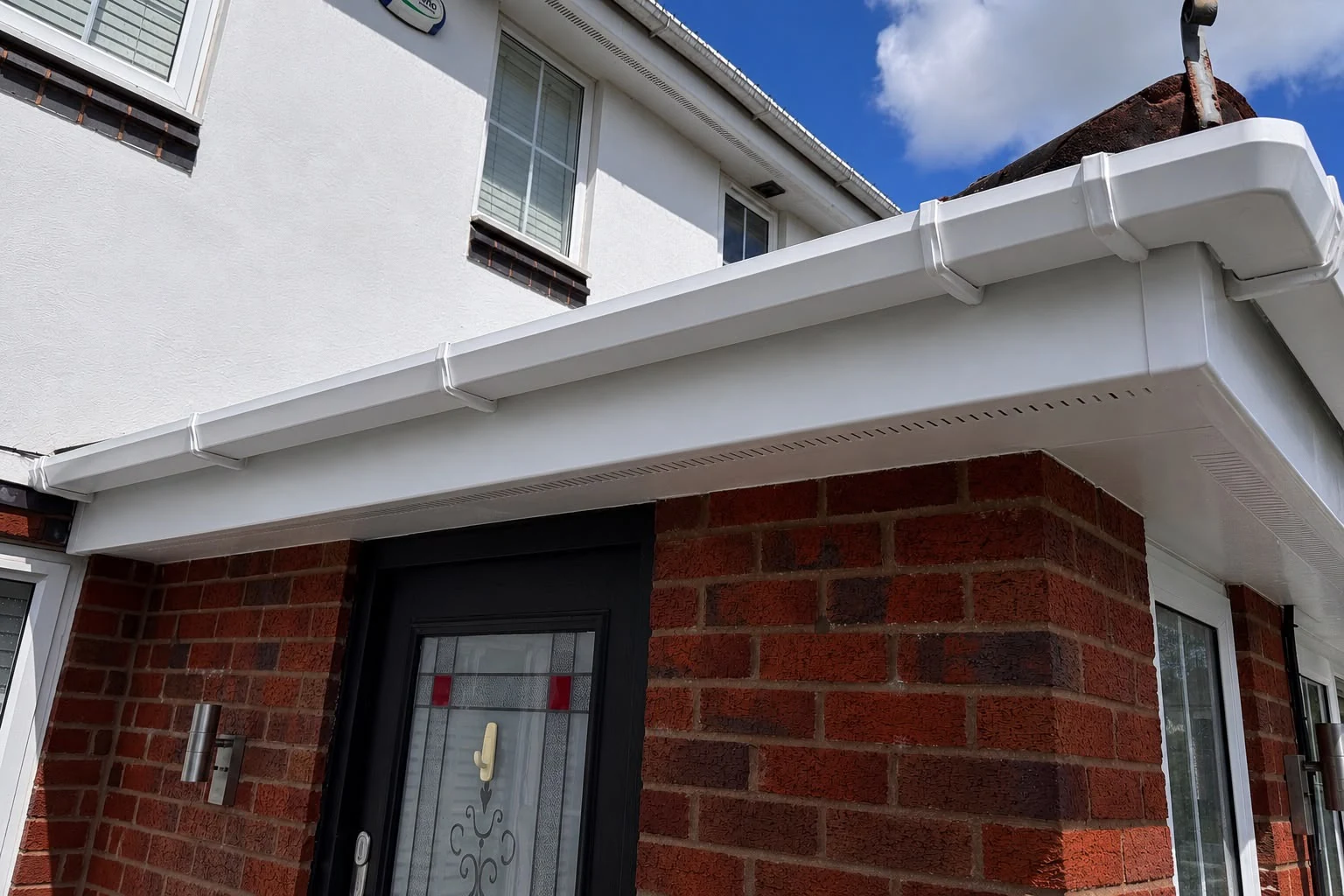 Streaked white gutter, fascia and soffit before exterior cleaning