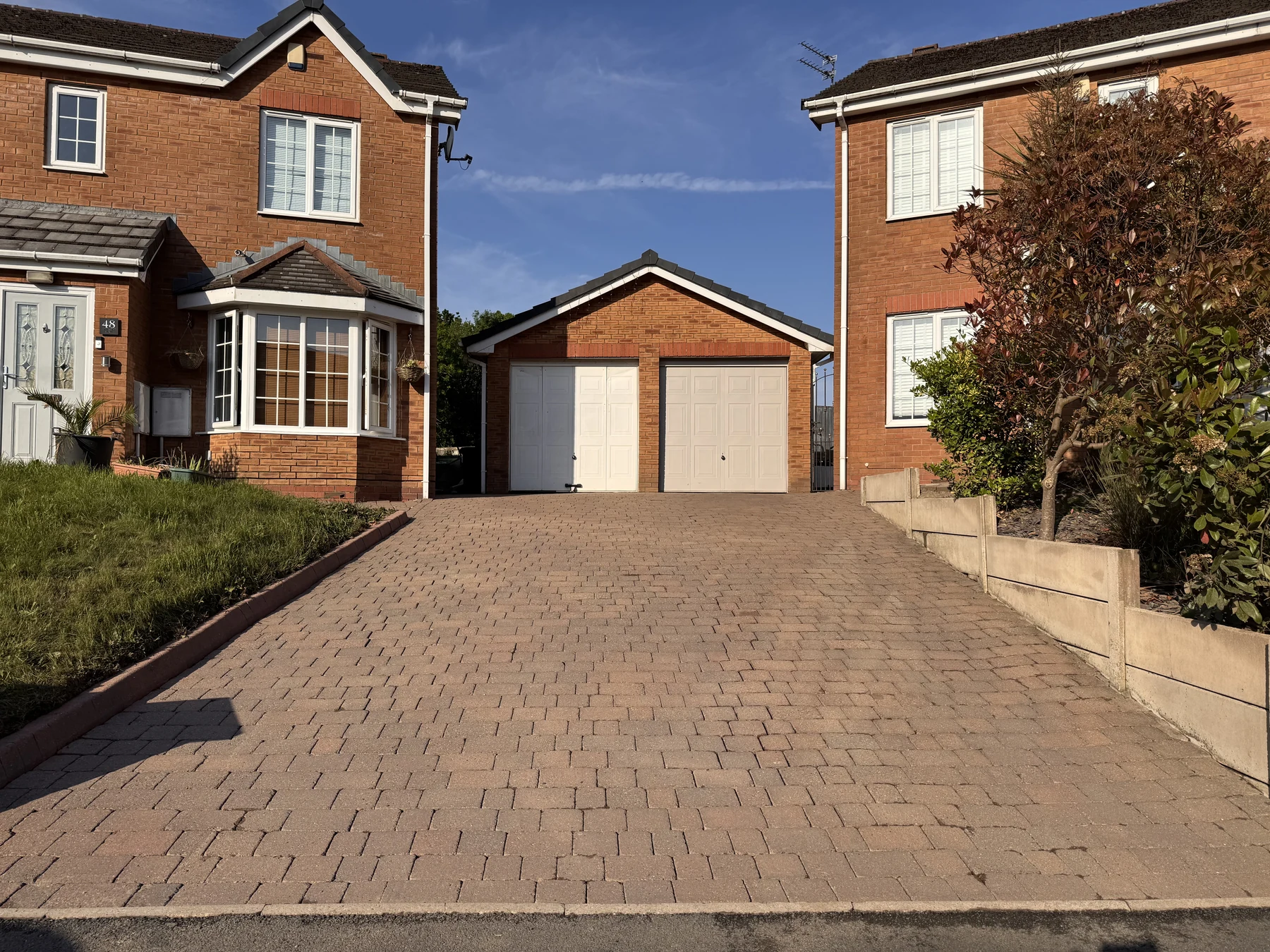 The same paved driveway after professional exterior cleaning