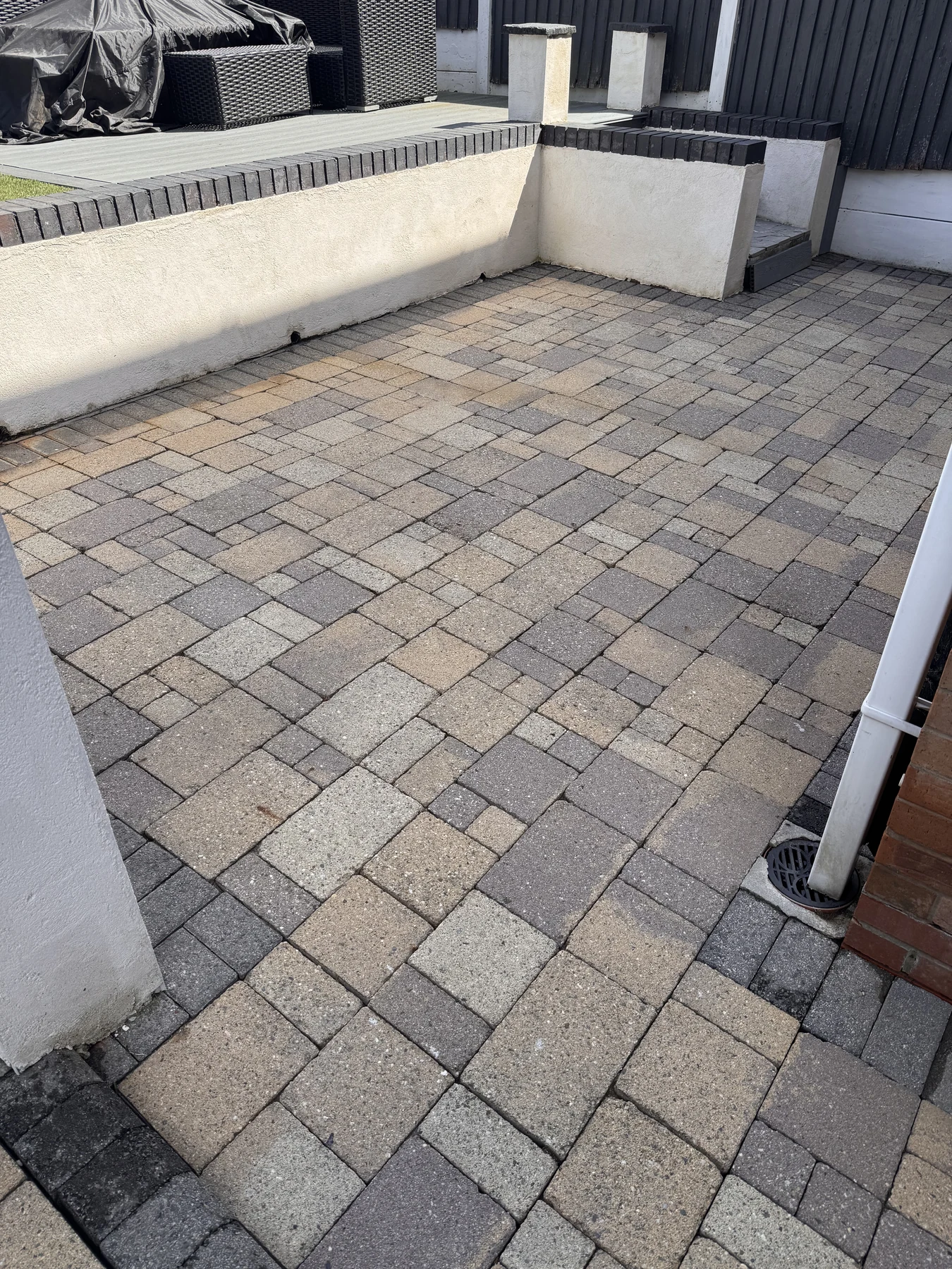 The same paved patio after professional cleaning