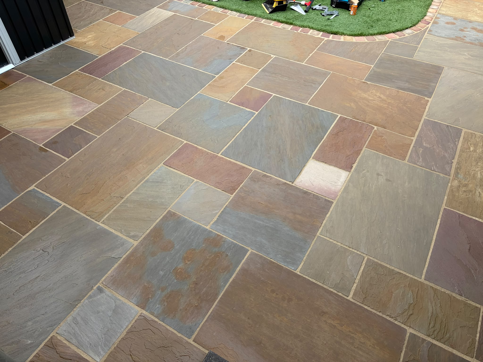 Natural stone patio before and after professional exterior cleaning after